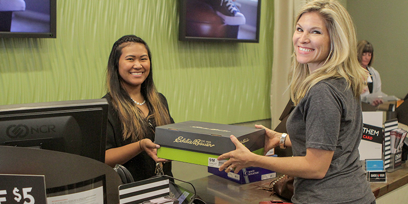 Woman donating shoes in DSW store